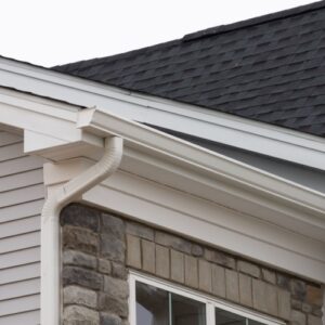 A white gutter system attached to the roof of a house that had a gutter replacement in San Antonio, TX